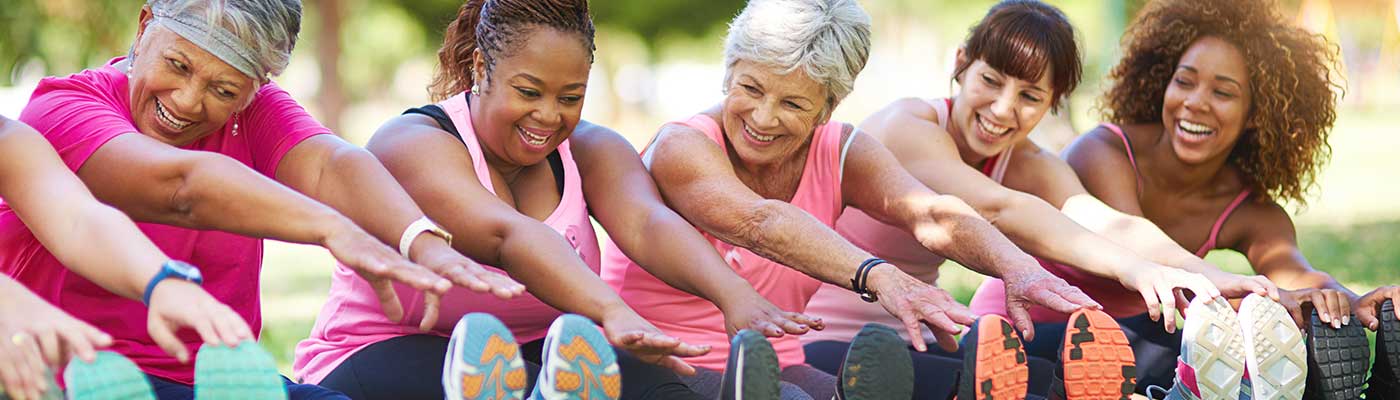 Women stretching in park