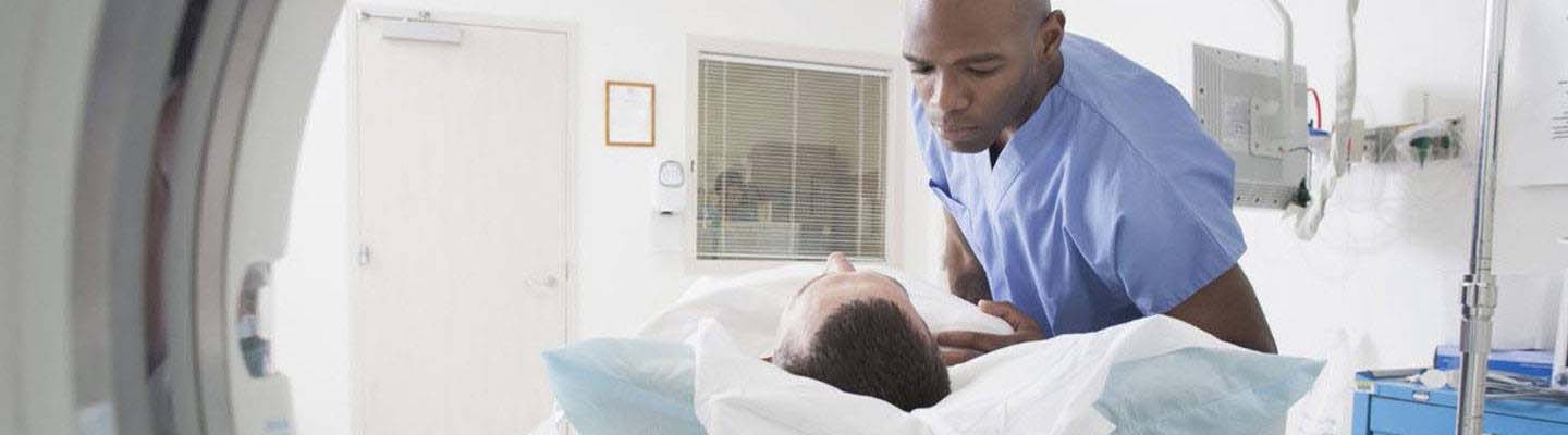 Imaging technician assisting patient