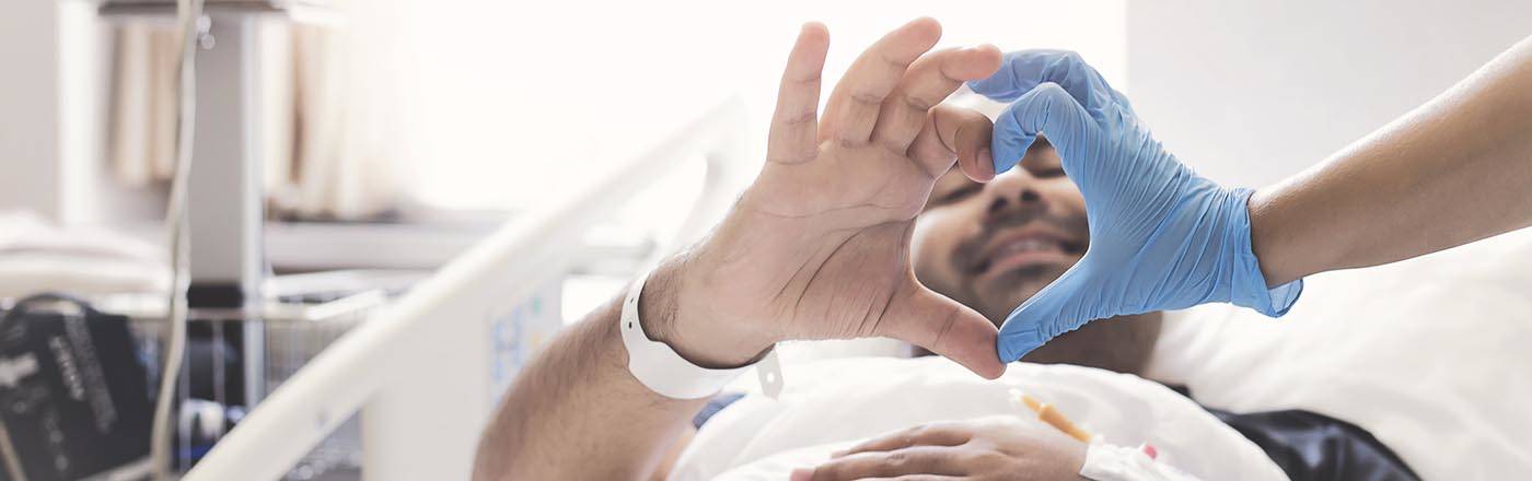 patient and nurse making a heart shape with hands